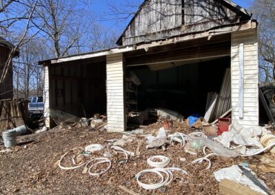 a garage with debris all over the ground in front of it to show our yard waste removal services in frederick md