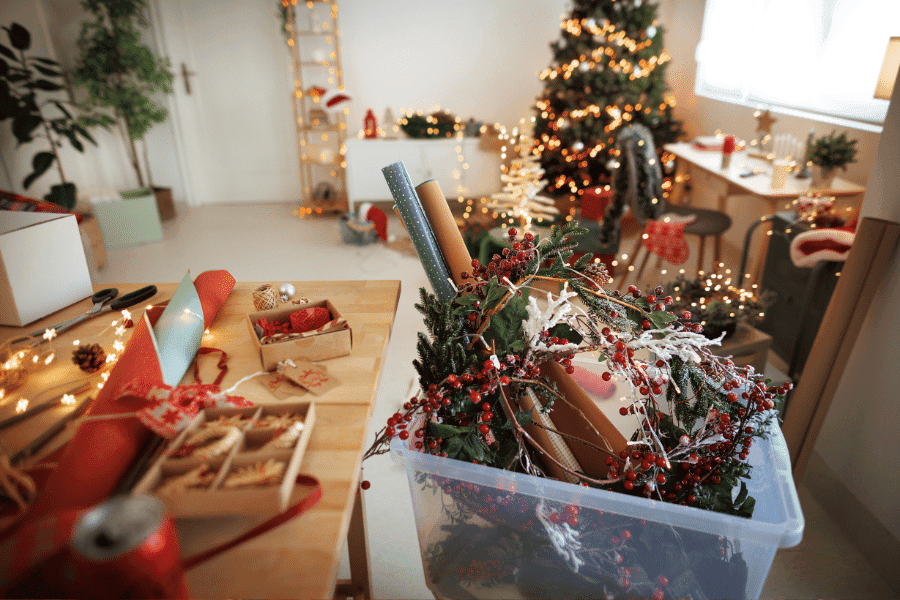 gift wrapping materials and christmas decorations to represent holiday prep