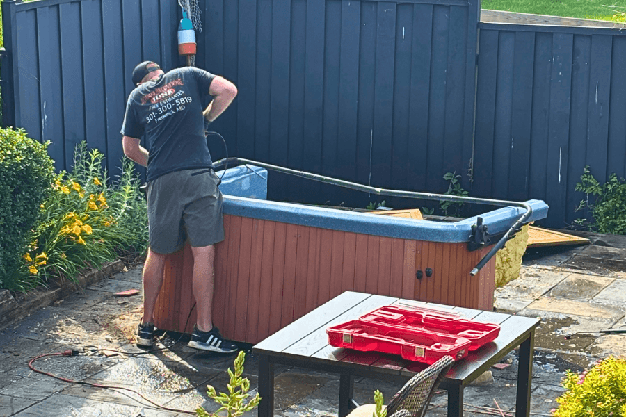 hot tub removal frederick md Always Recovering Junk employee dismantling a hot tub during hot tub removal